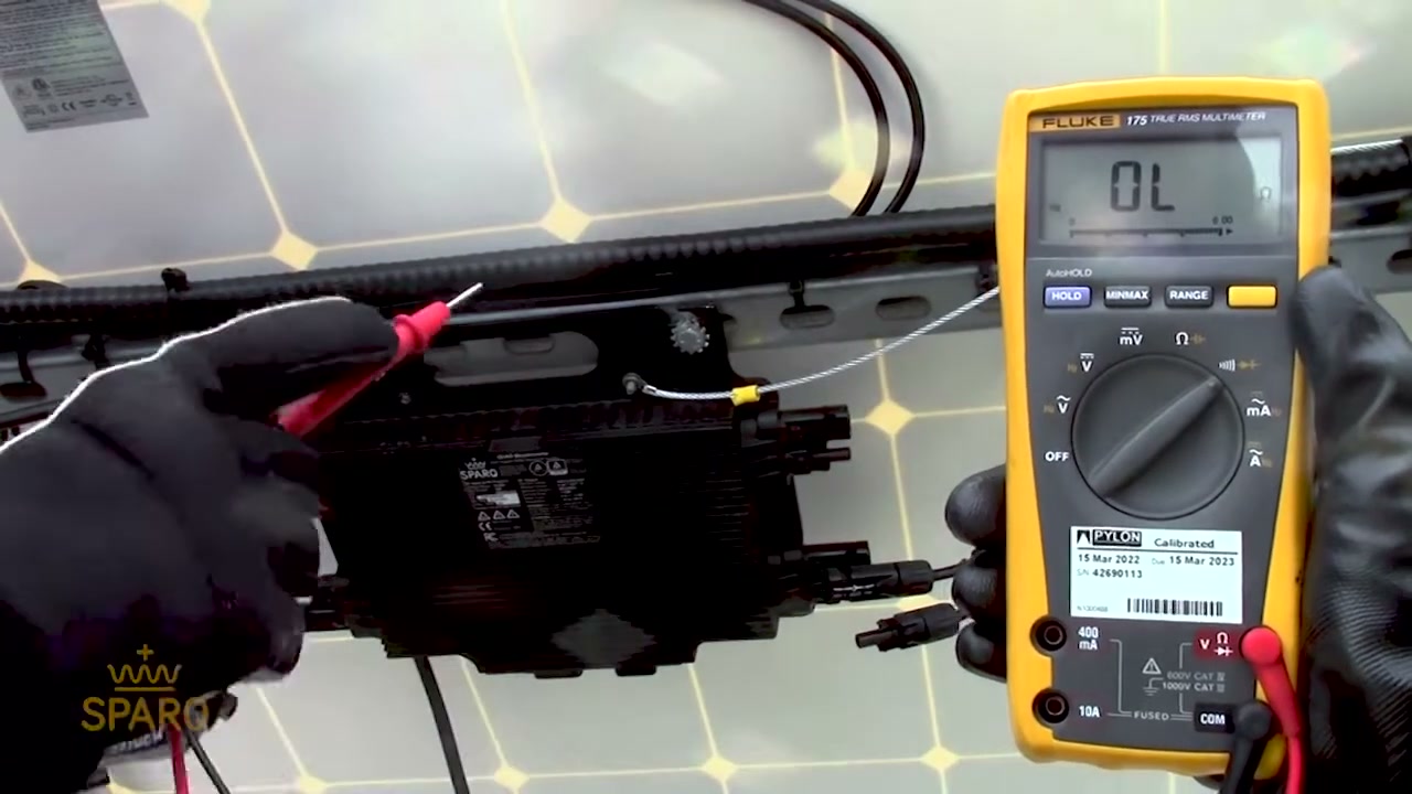 A multimeter's probes on the mounted Quad, checking continuity between the equipment ground and the system ground